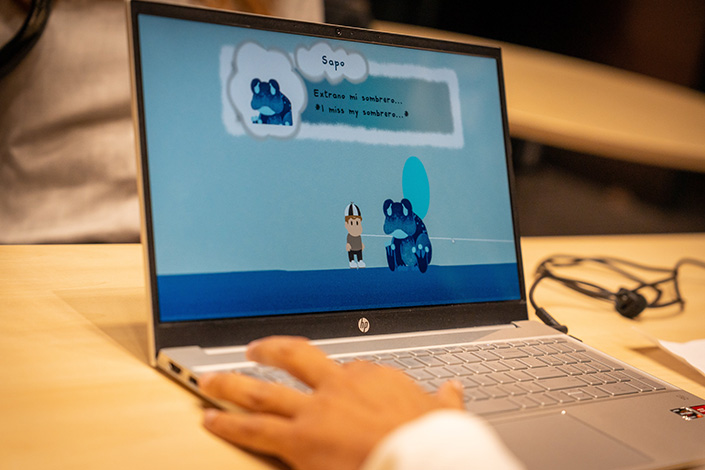 A person plays a video game on a laptop.