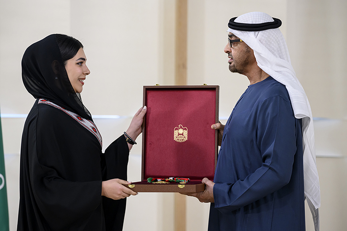 Soraya Gorgash receives box with medal inside from His Highness Scheikh Mohamed Bin Zayed Al Nahyan
