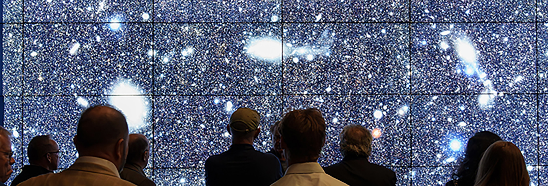 People looking at screen of cosmos