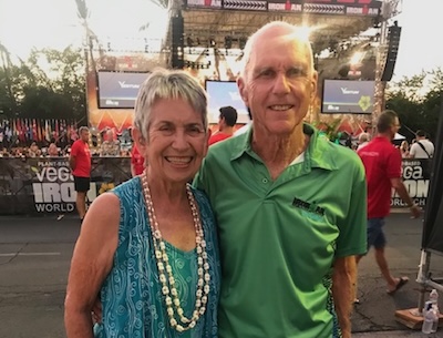 Photo of a smiling woman and man at an Ironman celebration event