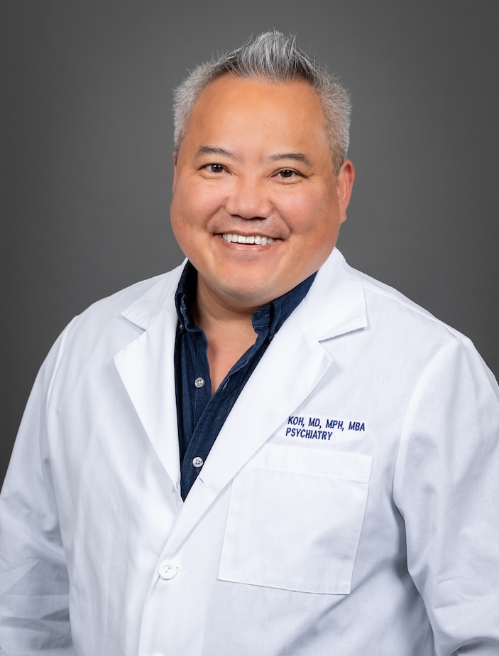 Headshot of doctor with gray hair and white lab coat