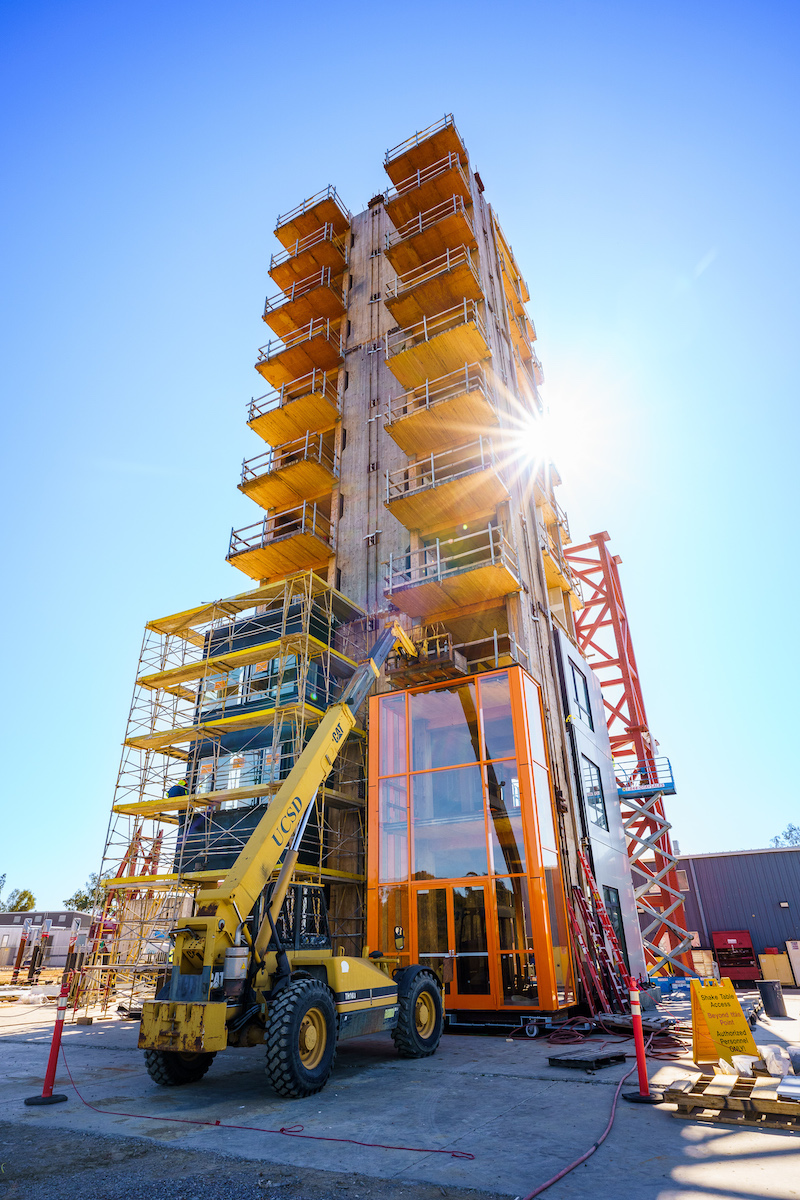 Picture of a 10-story cross-laminated timber building with a three-story glass facade. 