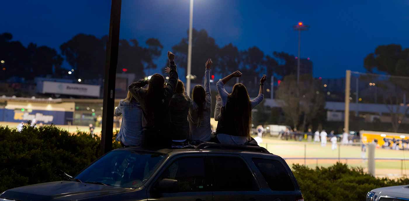 Image: Students nearby cheer on the Tritons