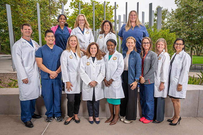 Large group of clinicians stands in two rows