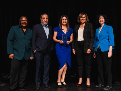 A group of campus leaders pose for a photo with award winner Maricela Alvarado, Director of Online Student Experience.