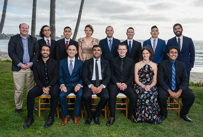 Group poses for photo with ocean in background