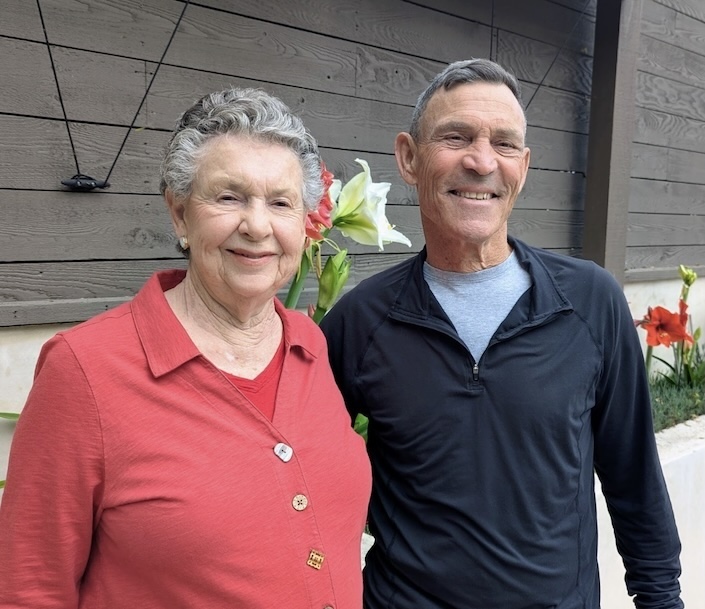 Woman in coral sweater with man smiling