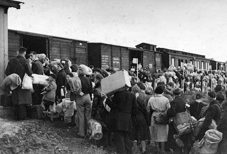 Image: 'Jews boarding a deportation train at Westerbork transit camp in the Netherlands.'