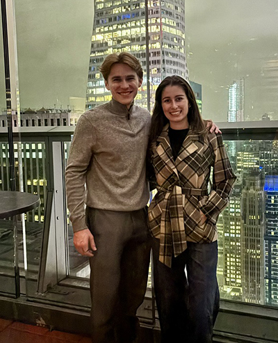 Weston Bell Geddes and Ellie Fausett against cityscape.