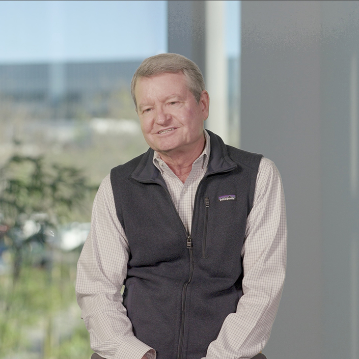 Portrait of John Wixted giving interview in collared shirt and black vest