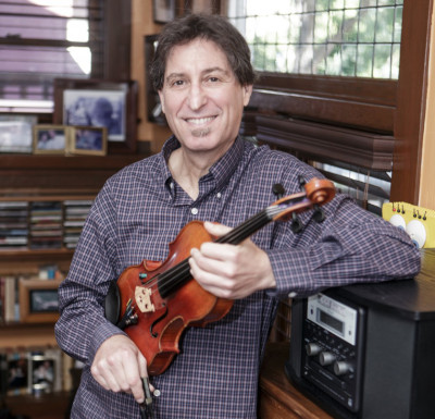Yale Strom holding violin