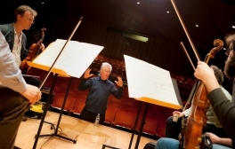 Reynolds conducting music students on stage