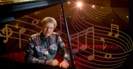 A large group of singers on stage at the Metropolitan Opera performing 