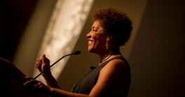 Carrie Mae Weems speaking at a podium at UC San Diego