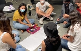 Group of high school students participating in an art project as part of a mental health workshop.
