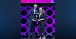 Grace Riggs on stage receiving award