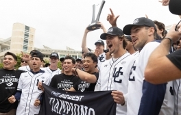 Triton baseball players raise Big West championship trophy in celebration.