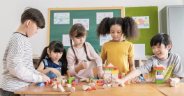Group of children playing with blocks in classroom