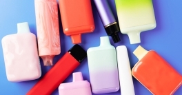 Disposable liquid vaporizers (e-cigarettes) on a blue background, vapes stock photo