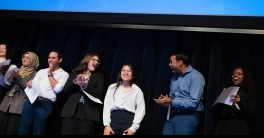 Iris Garcia-Pak gestures with her hands while delivering research talk on stage