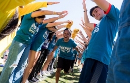 A student runs through a human tunnel during a welcome week event