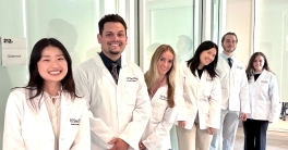 Six Atkinson Physician Assistant Education Program students shown smiling while wearing new white coats.