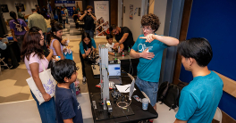 Students interacting with STEM fair participants