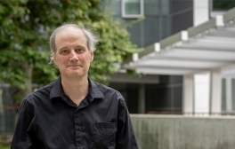 Miller Puckette standing in front of Atkinson Hall at UC San Diego Qualcomm Institute