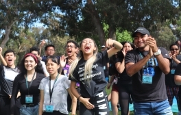 A group of Summer Bridge students smile and cheer.