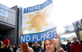 Activist holds a sign during a climate change demonstration.