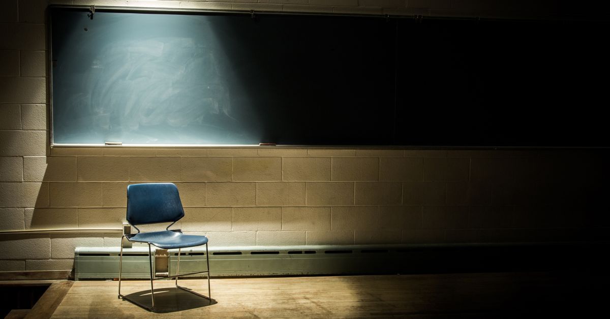 Stock image of classroom with lonely chair at blaokboard