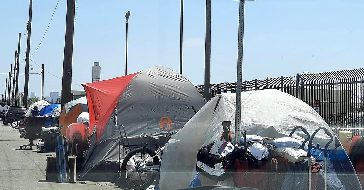 An encampment made of tents in which people experiencing homelessness live on a San Diego street.