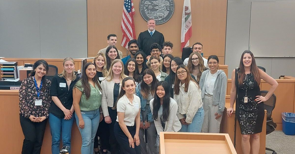 Pre-law student group poses in courthouse with judge