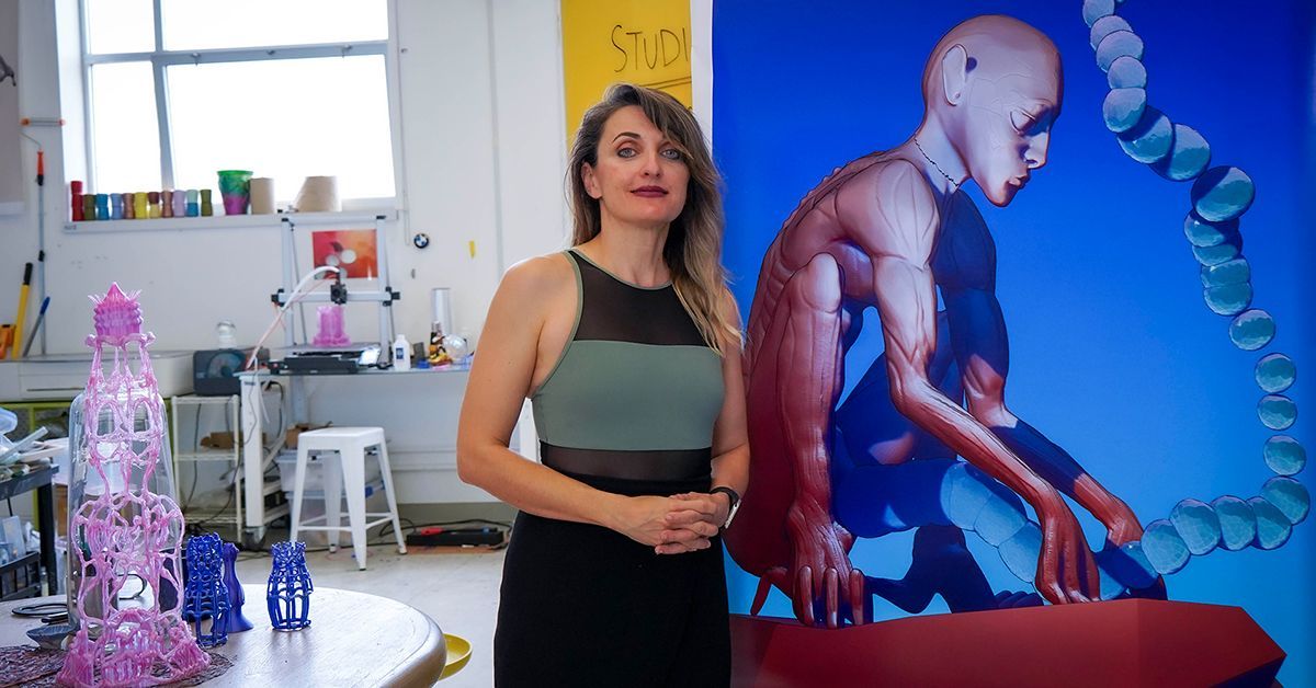 Woman next to painting in studio