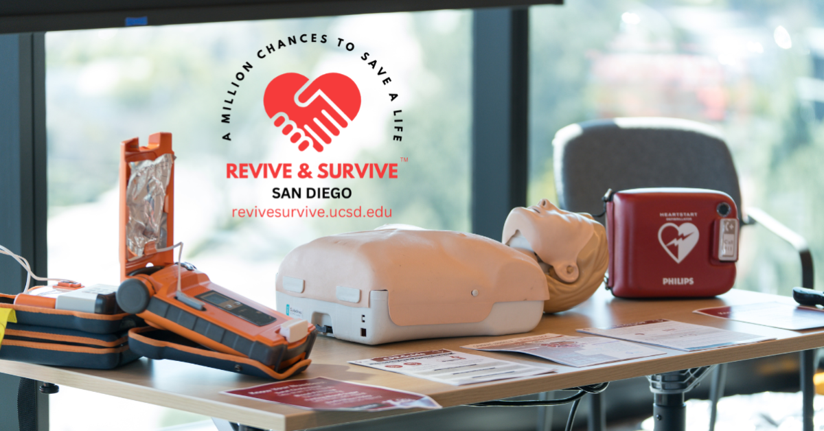 Image of a cardiopulmonary resuscitation (CPR) mannequin and an automated external defibrillator (AED) on a table with a logo Revive & Survive San Diego reading 