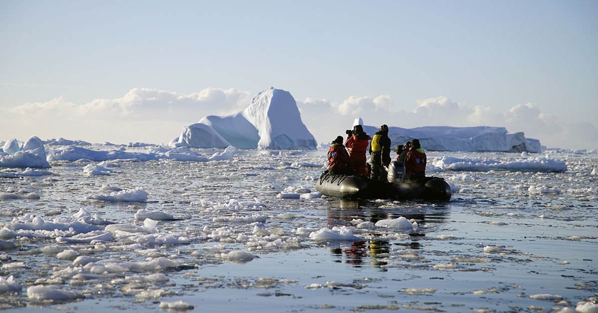 Travelers visiting Antarctica participate in a FjordPhyto science boat sampling activity. 