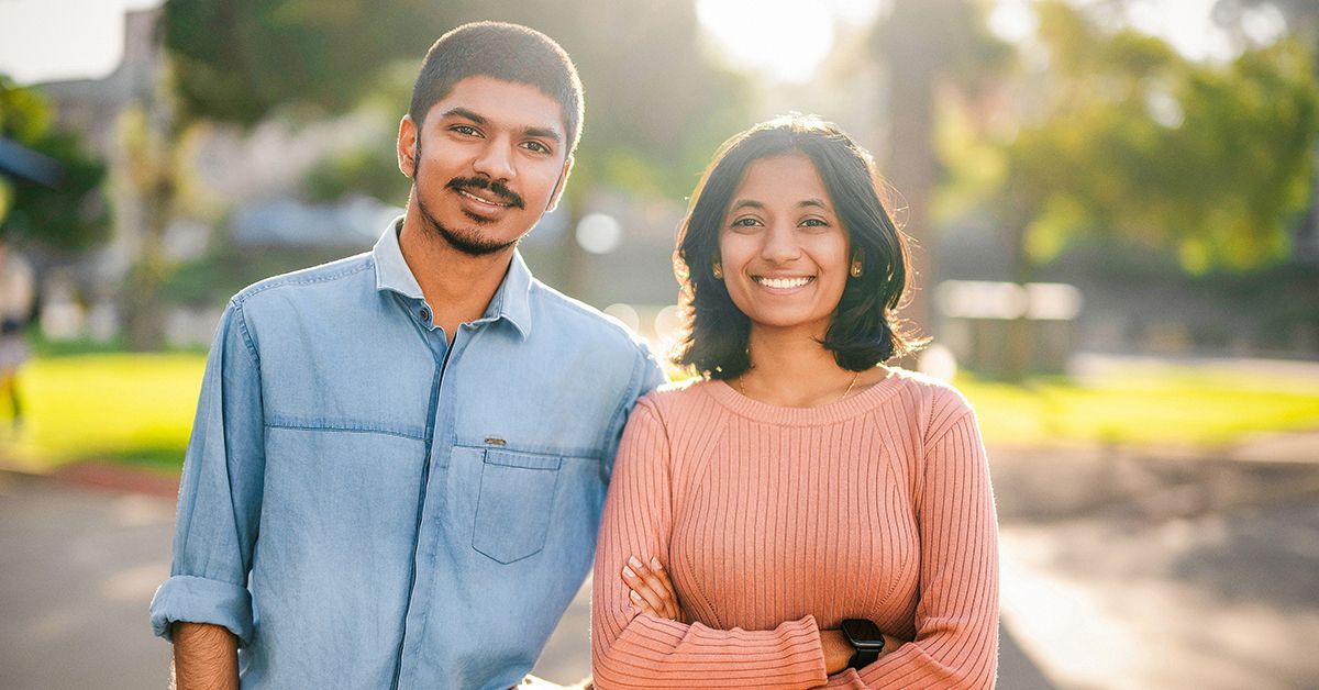 two students standing in the sun.