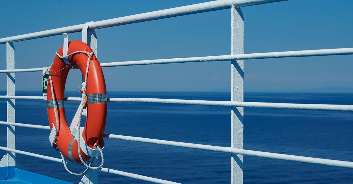 Orange life preserver affixed to cruise ship railing