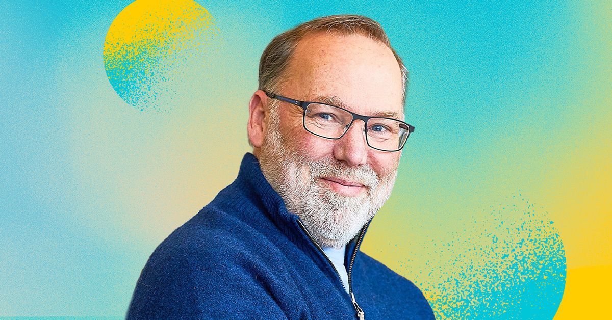 photo of Fred Ramsdell wearing a blue sweater over a stylized graphic