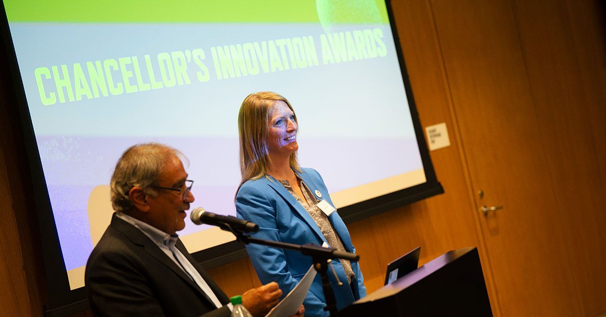 Chancellor Khosla at podium as Allison Cusick stands next to him