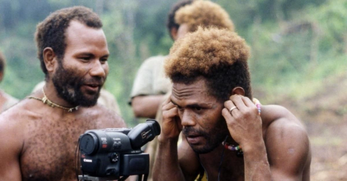 Young men videotaping sango dance practice.