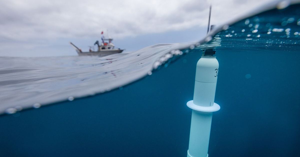A Navy officer deploys a buoy from the USS Pearl Harbor 