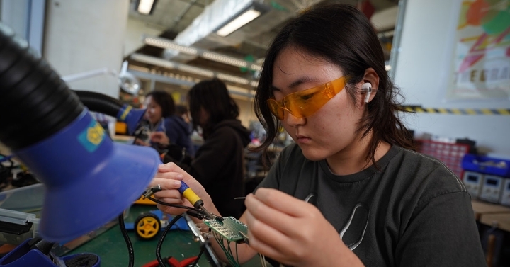 A student solders electronics 