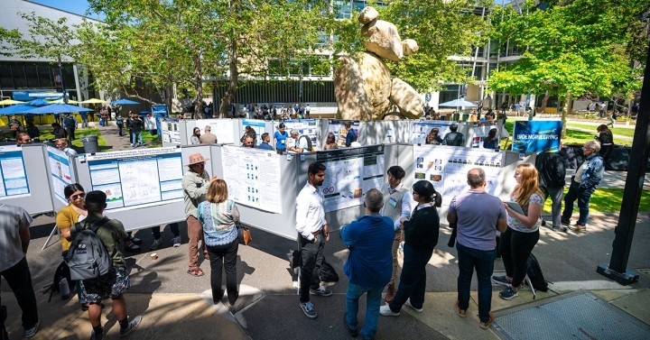 Students present research posters in Bear Courtyard