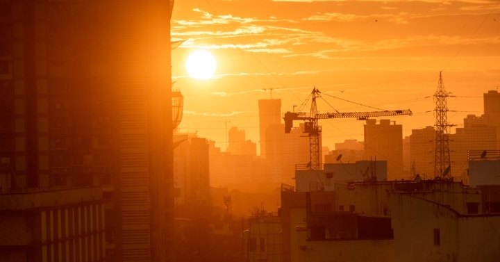 A skyline with a bright sun shining down.