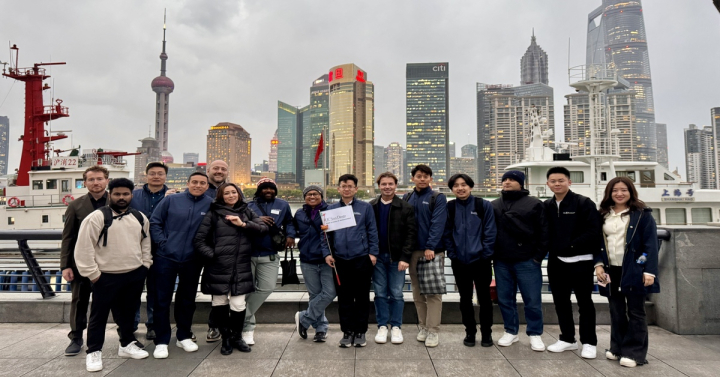 Students posing in front of Beijing skyline 