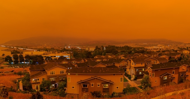 Skyline of deep orange haze and smoke over San Francisco Bay Area homes during 2020 wildfires