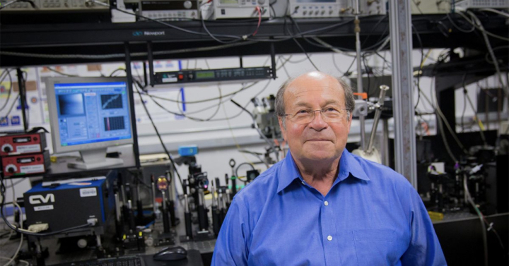 Professor Fainman standing in front of a lab bench covered with wires at his lab. 