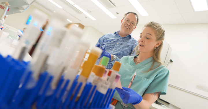 Davey Smith and researcher in lab doing test procedures