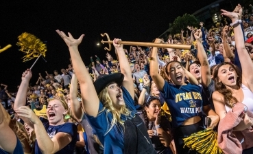 Students cheer during a water polo game.